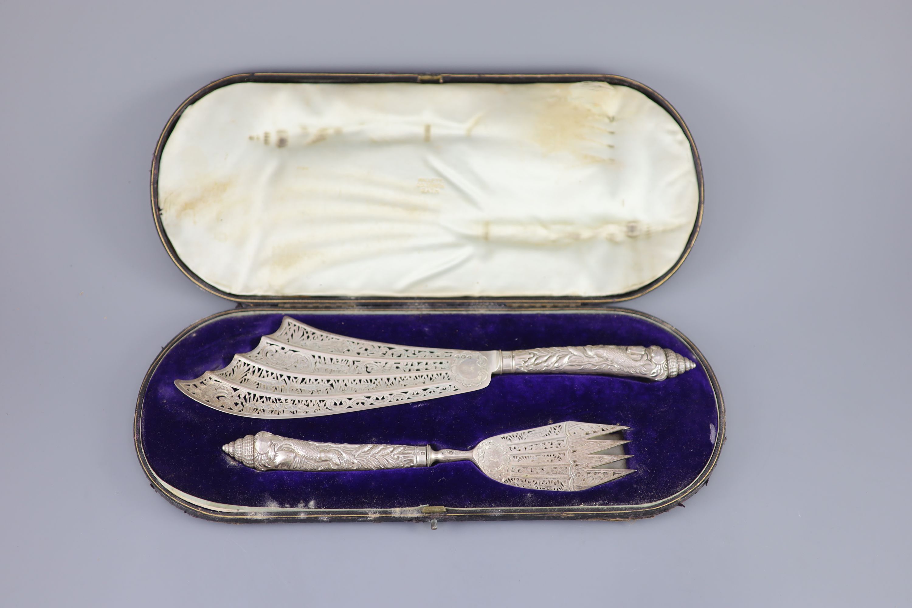 A cased ornate pair of Victorian silver fish servers, Aldwinckle & Slater